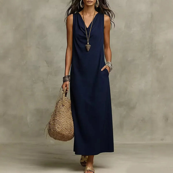 Front view of sleeveless maxi dress in white showing V-neck design and loose fit drape
