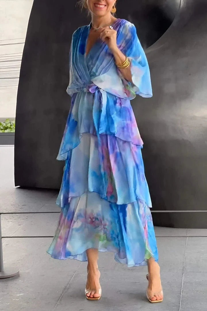 Woman wearing Spring Floral Tiered Chiffon Dress in blue watercolor print with V-neckline and long sleeves