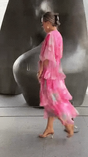 Woman twirling in Spring Floral Tiered Chiffon Dress revealing movement and drape of tiered skirt