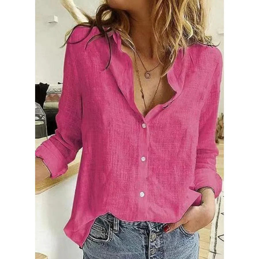 Woman wearing a pink cotton long sleeve shirt with button-front closure and relaxed fit paired with jeans