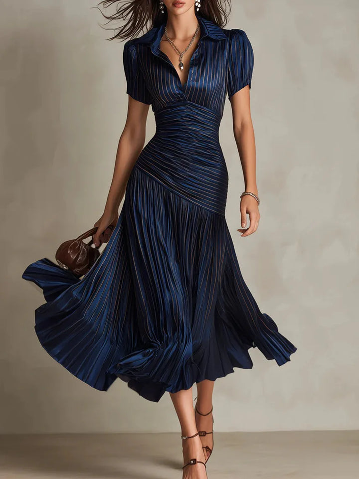 Pleated midi dress in navy with collared neckline, ruched waist, and flowing A-line skirt