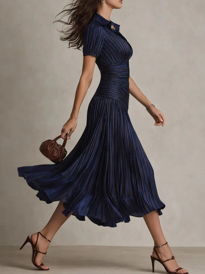 Side view of pleated midi dress showing diagonal ruching detail through fitted bodice
