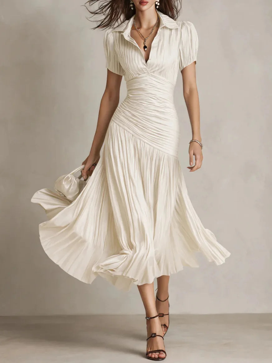 Close-up of smooth satin finish fabric and vertical pleating on midi dress skirt