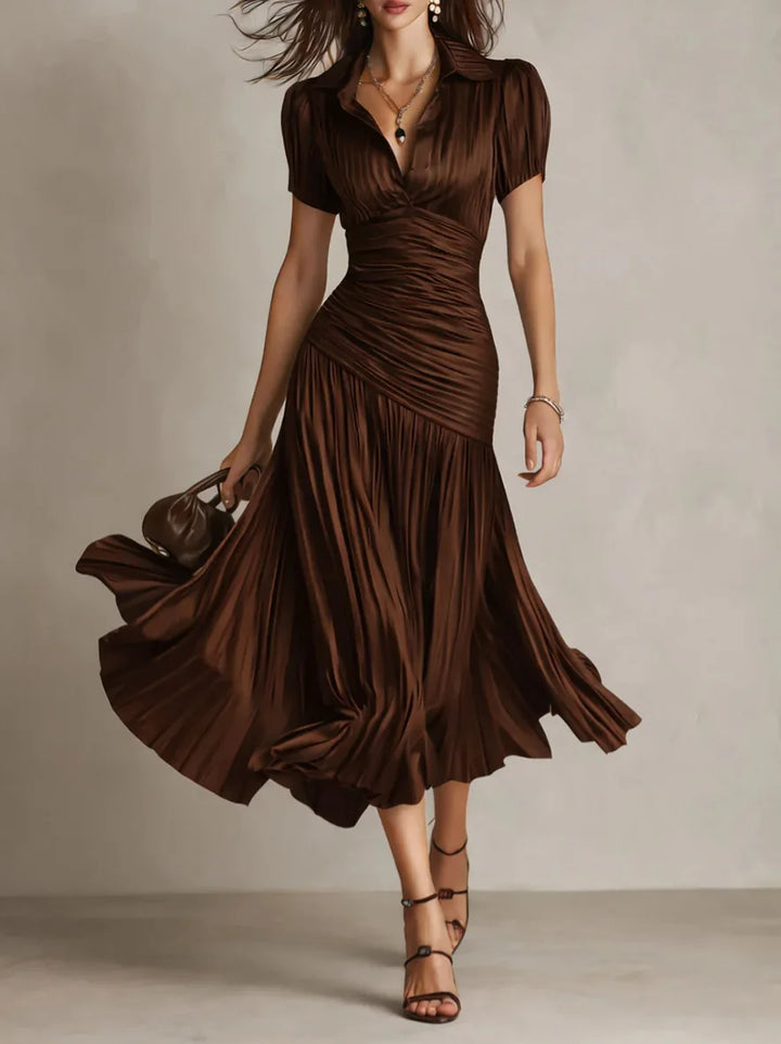 Full-length view of navy pleated midi dress with mid-calf hemline and movement