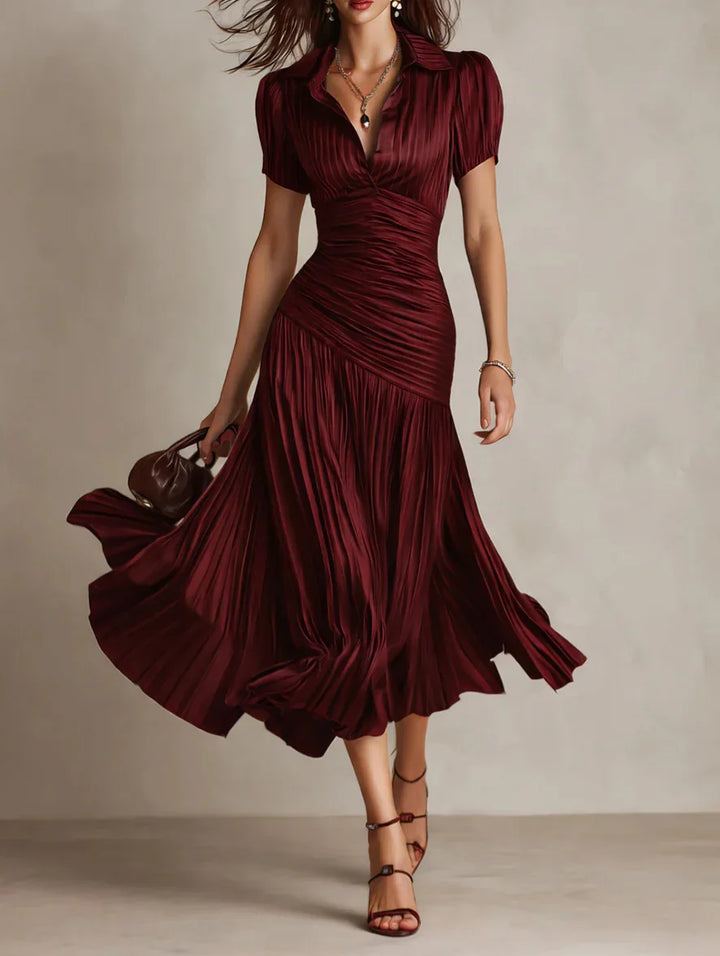Detail of collared neckline and fitted bodice on pleated satin midi dress