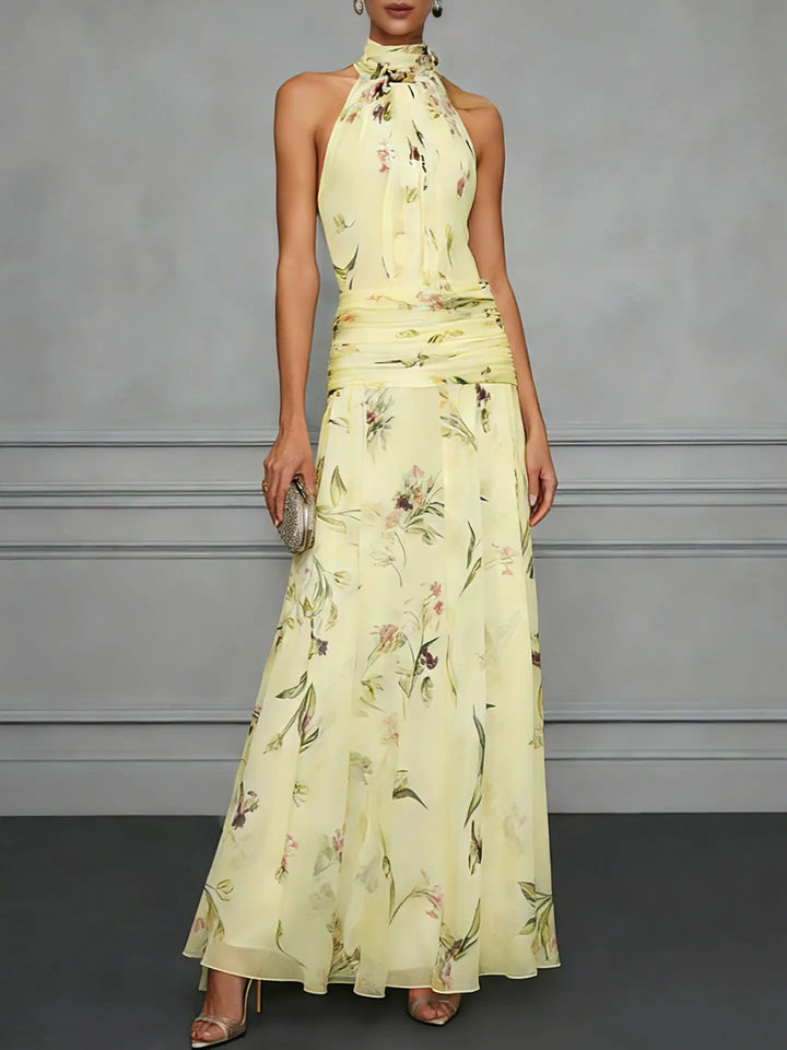 Side view of floral halter maxi dress showing flowy A-line silhouette and botanical print detail