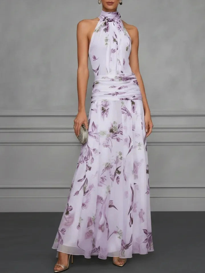 Close-up of ruched waist detail on floral halter maxi dress with gathered panel and natural waistline