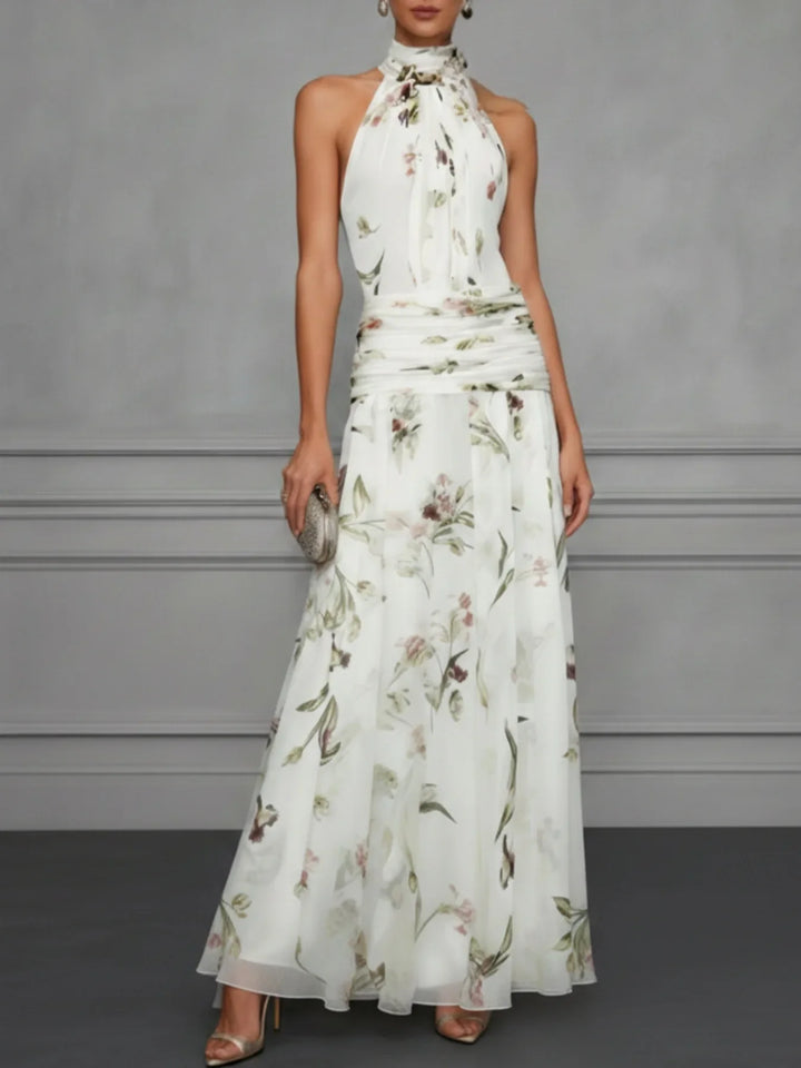 Full-length floral halter maxi dress styled with strappy heels for summer wedding or garden party