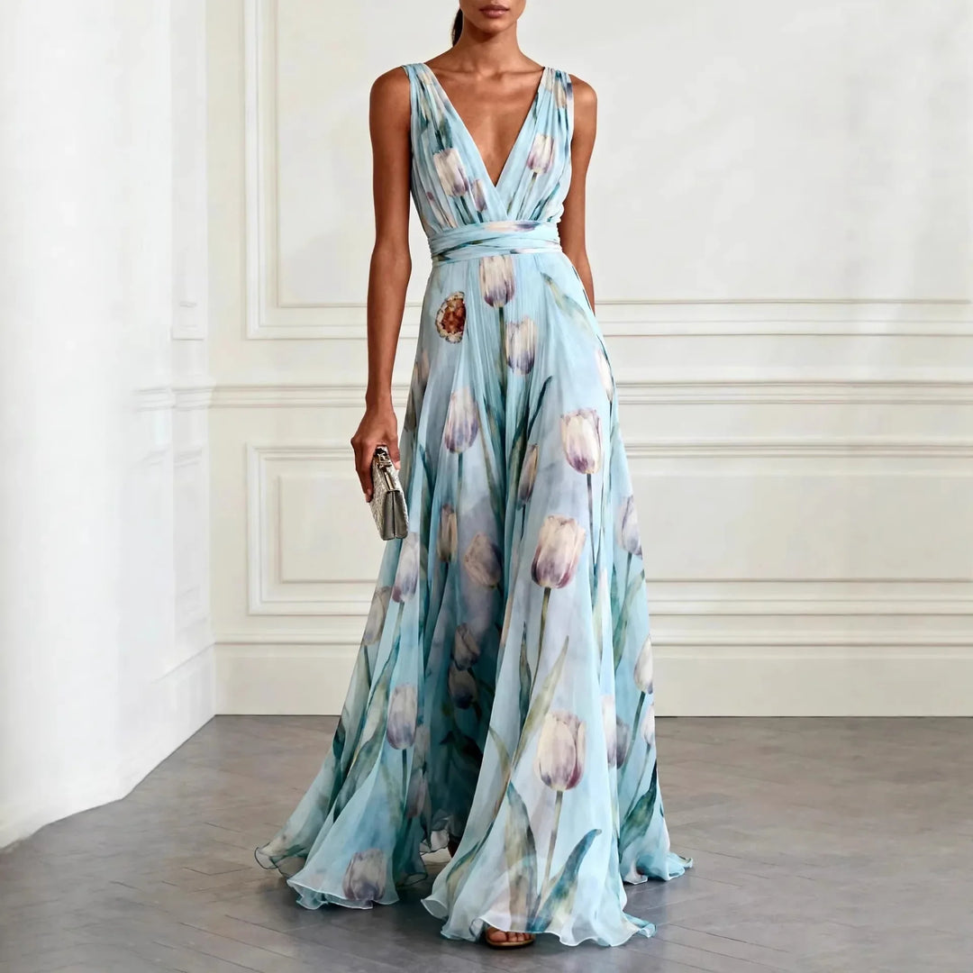 Light blue floral maxi wedding guest dress with deep V-neckline and flowing floor-length skirt