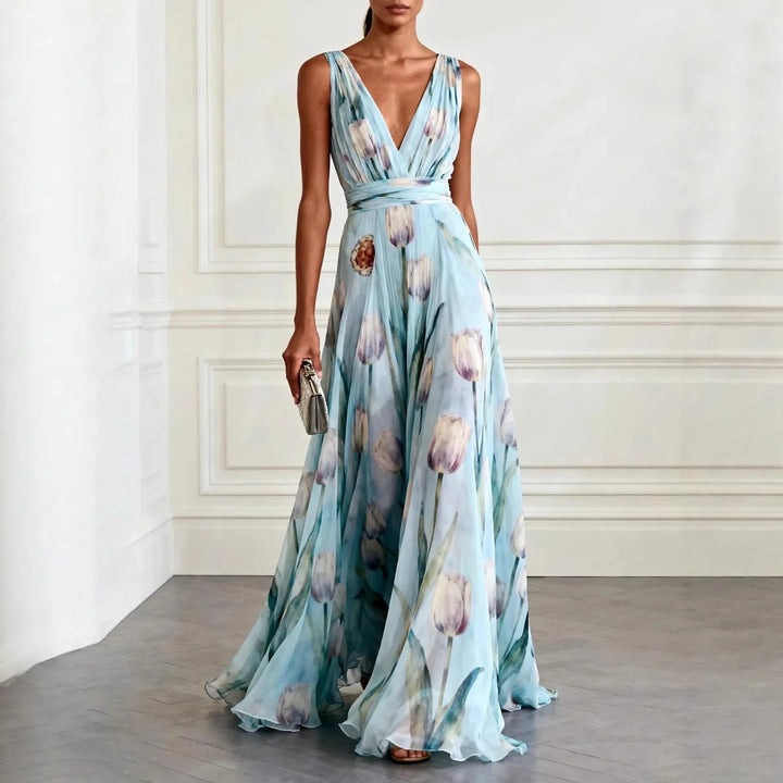Light blue floral maxi wedding guest dress with deep V-neckline and flowing floor-length skirt
