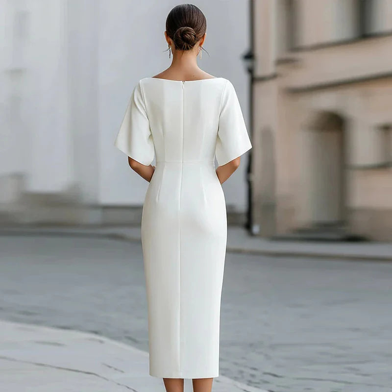 Side view of fitted midi dress showing clean silhouette and structured fabric drape