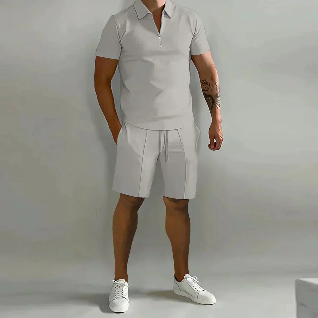 Detail of half-zip polo collar and elastic waist shorts in matching cream