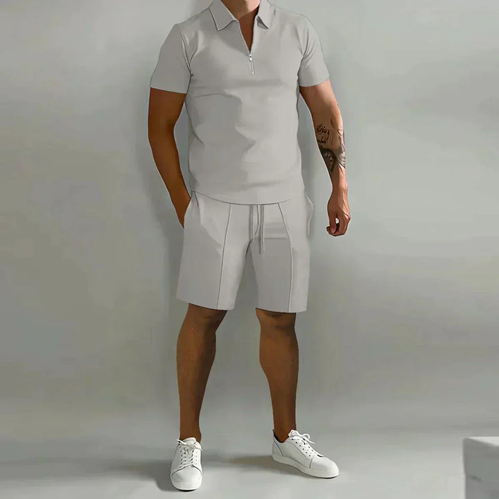 Detail of half-zip polo collar and elastic waist shorts in matching cream