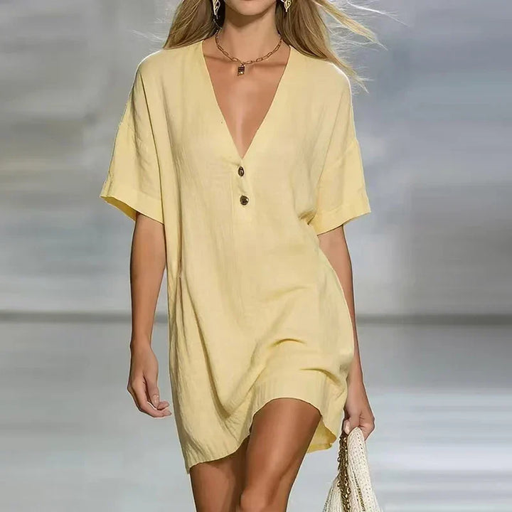 Woman wearing pale yellow V Neck Linen Shirt Dress with relaxed fit and button detail