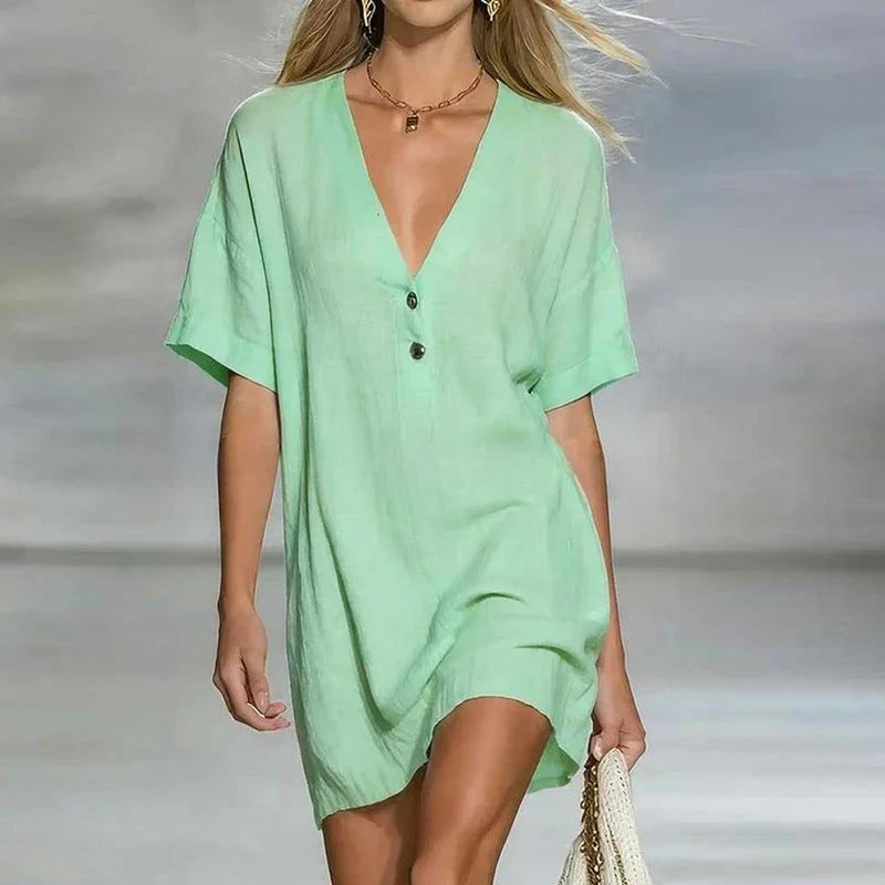 Side angle of loose fit V Neck Linen Shirt Dress with short sleeves and knee-length hem
