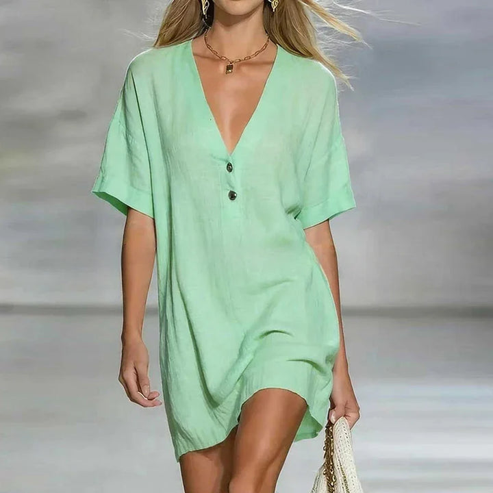 Side angle of loose fit V Neck Linen Shirt Dress with short sleeves and knee-length hem