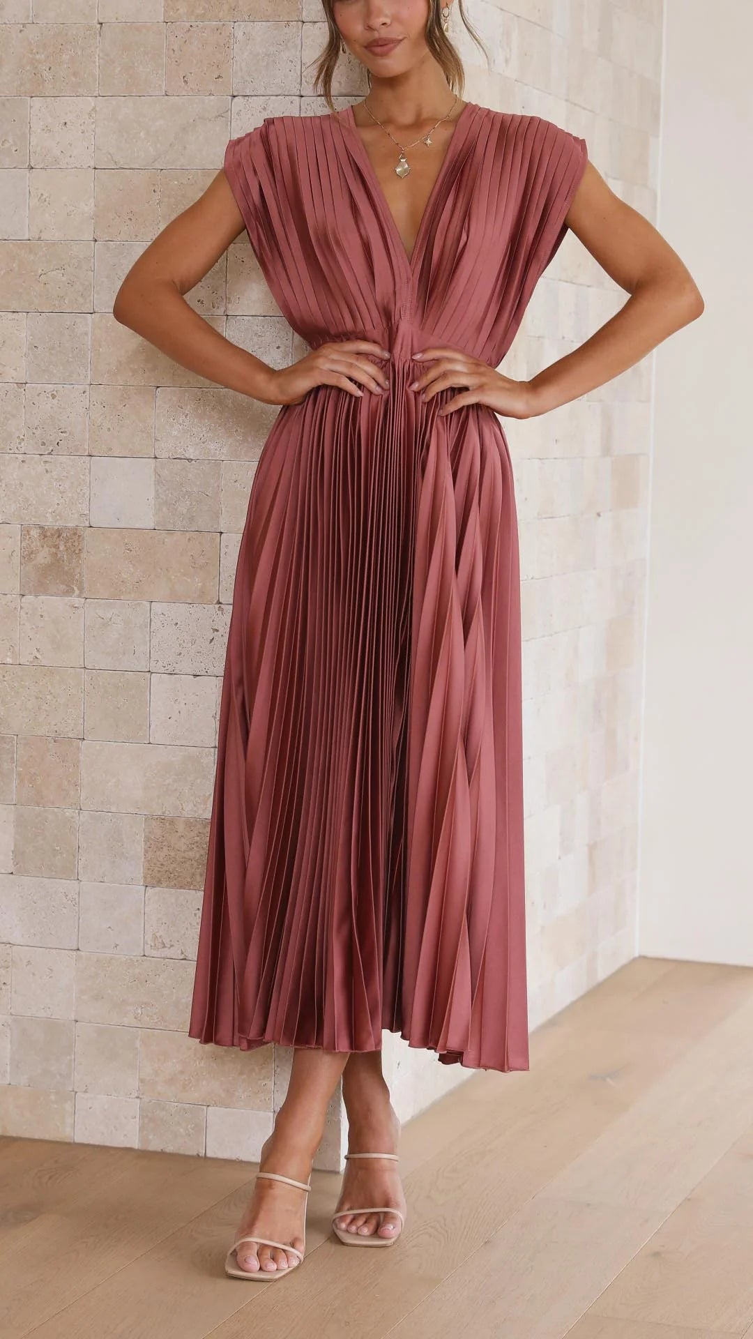 Woman wearing Elegant Pleated Maxi Dress V-Neck Flowing in dusty rose with draped neckline and full pleating