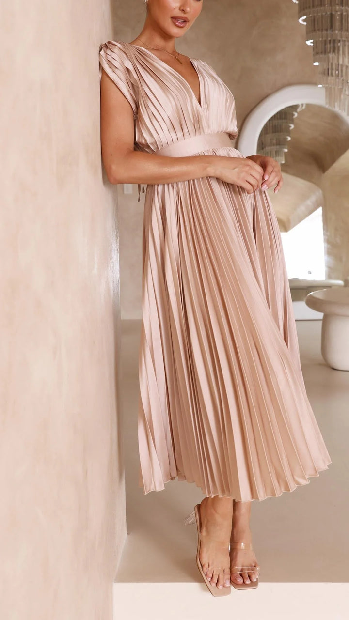 Movement shot of flowing pleated maxi dress with V-neckline