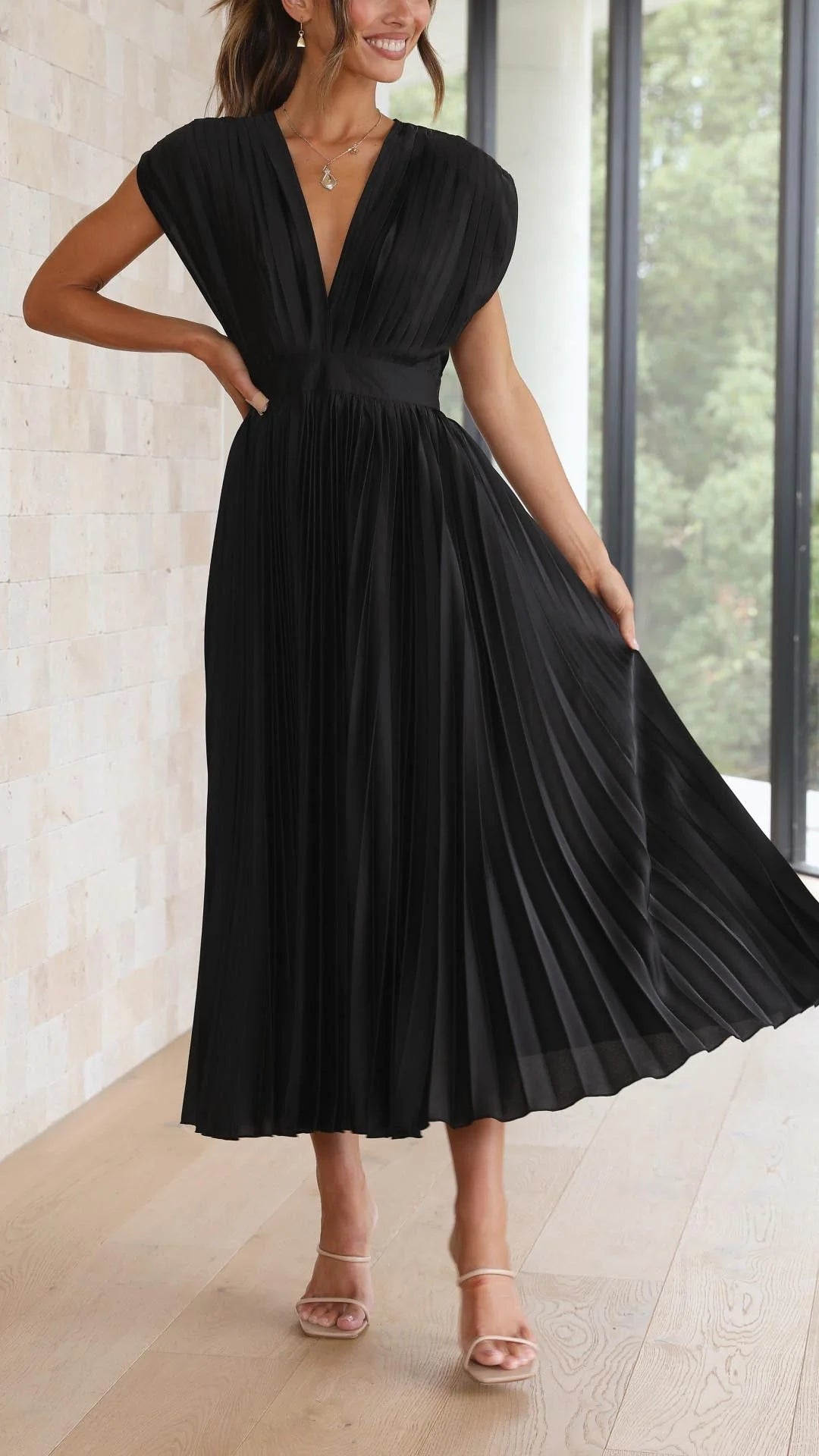 Side profile of draped V-neck and high-waisted pleated maxi dress