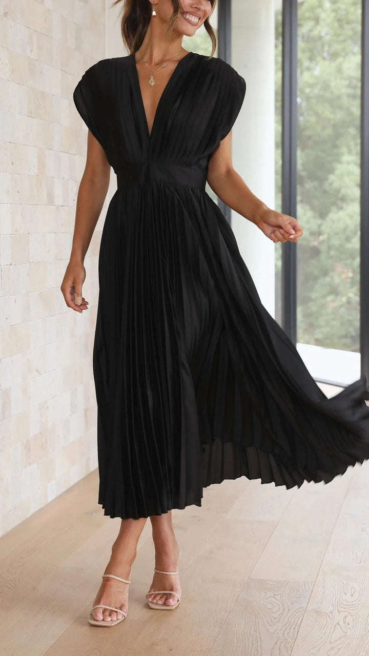 Close-up of cap sleeves and V-neckline on pleated maxi dress
