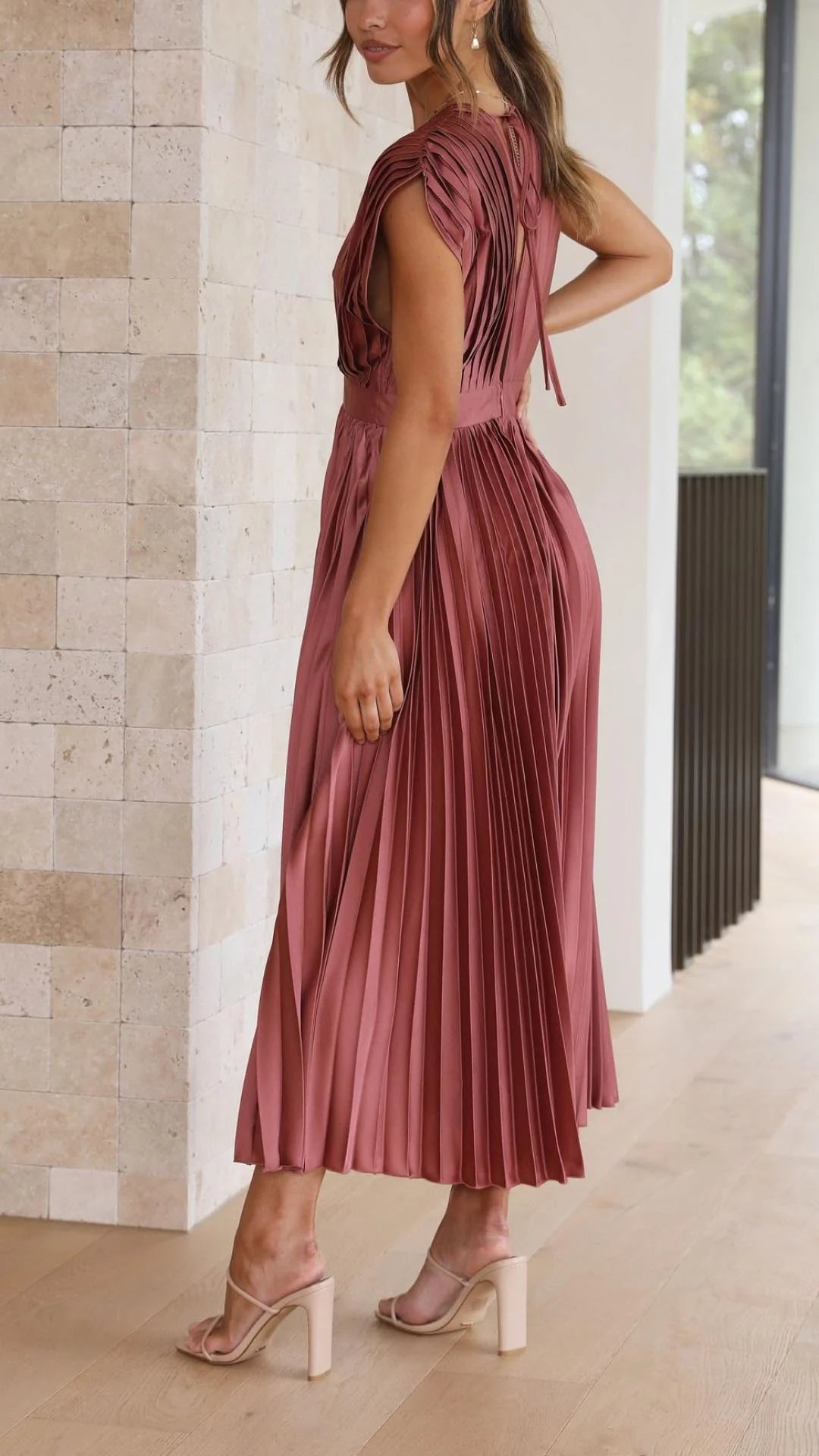 Detail shot of draped V-neck and pleated bodice on maxi dress