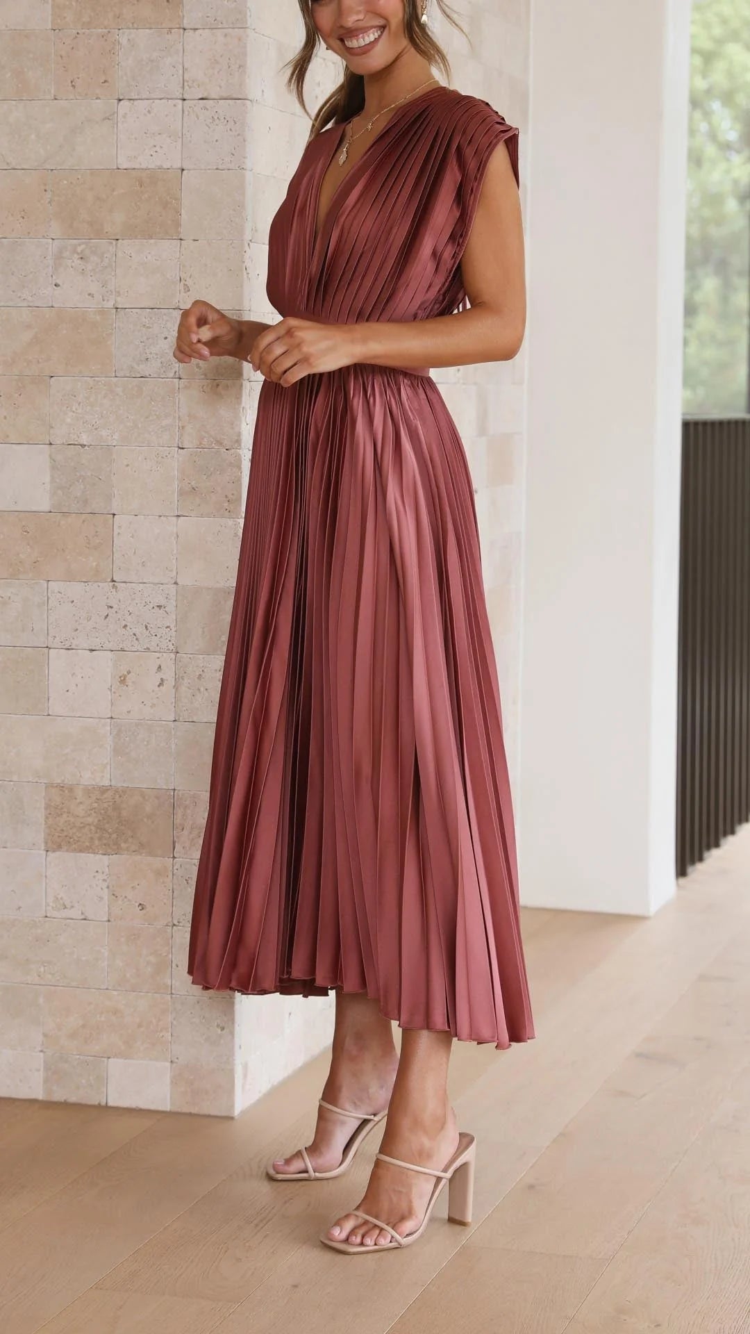 Full-length view of Elegant Pleated Maxi Dress V-Neck Flowing with strappy sandals