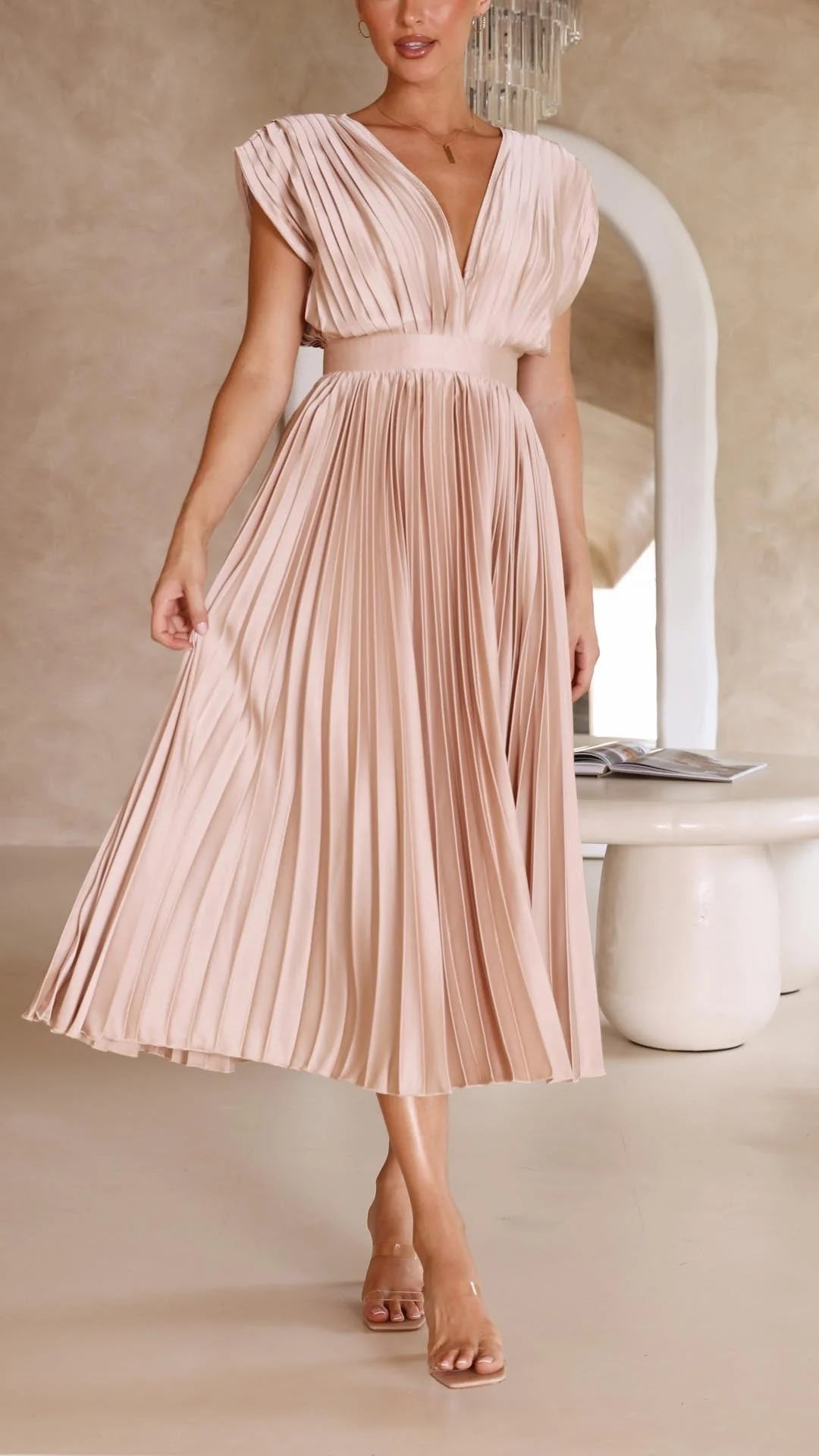 Back view of pleated maxi dress showing flowing skirt and cap sleeve detail