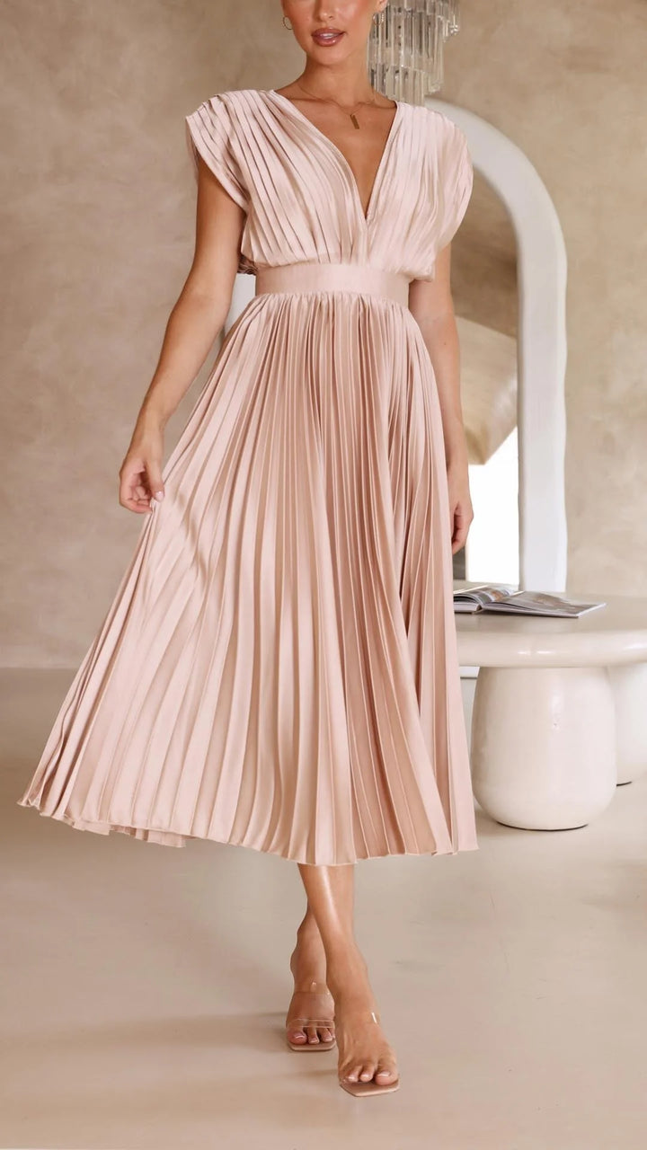 Back view of pleated maxi dress showing flowing skirt and cap sleeve detail
