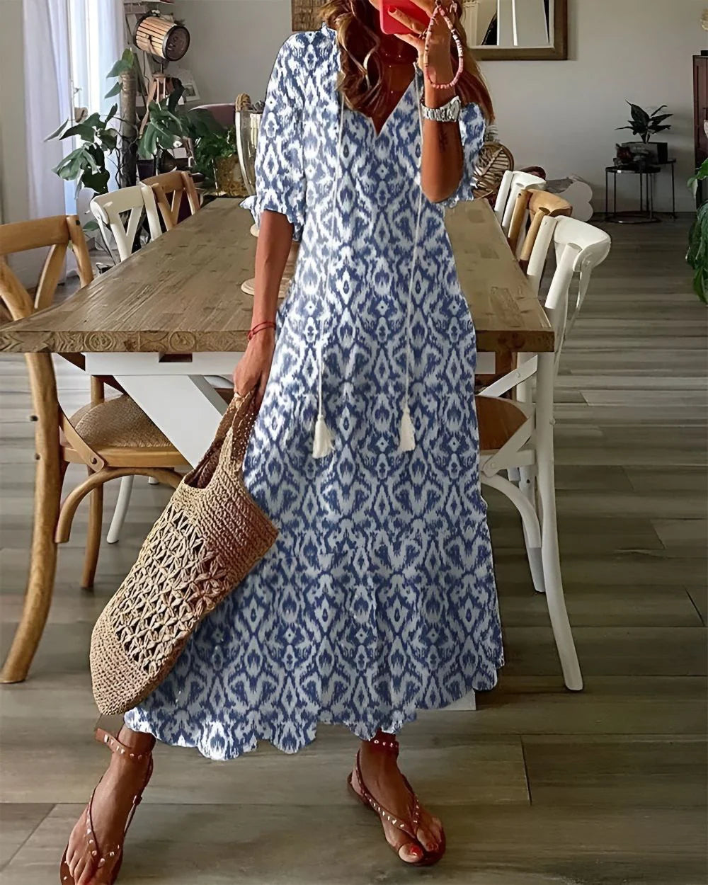 Woman wearing tassel tie front maxi dress with blue ikat print and short sleeves