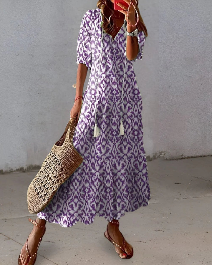 Side view of relaxed fit maxi dress with flowing skirt and all-over print