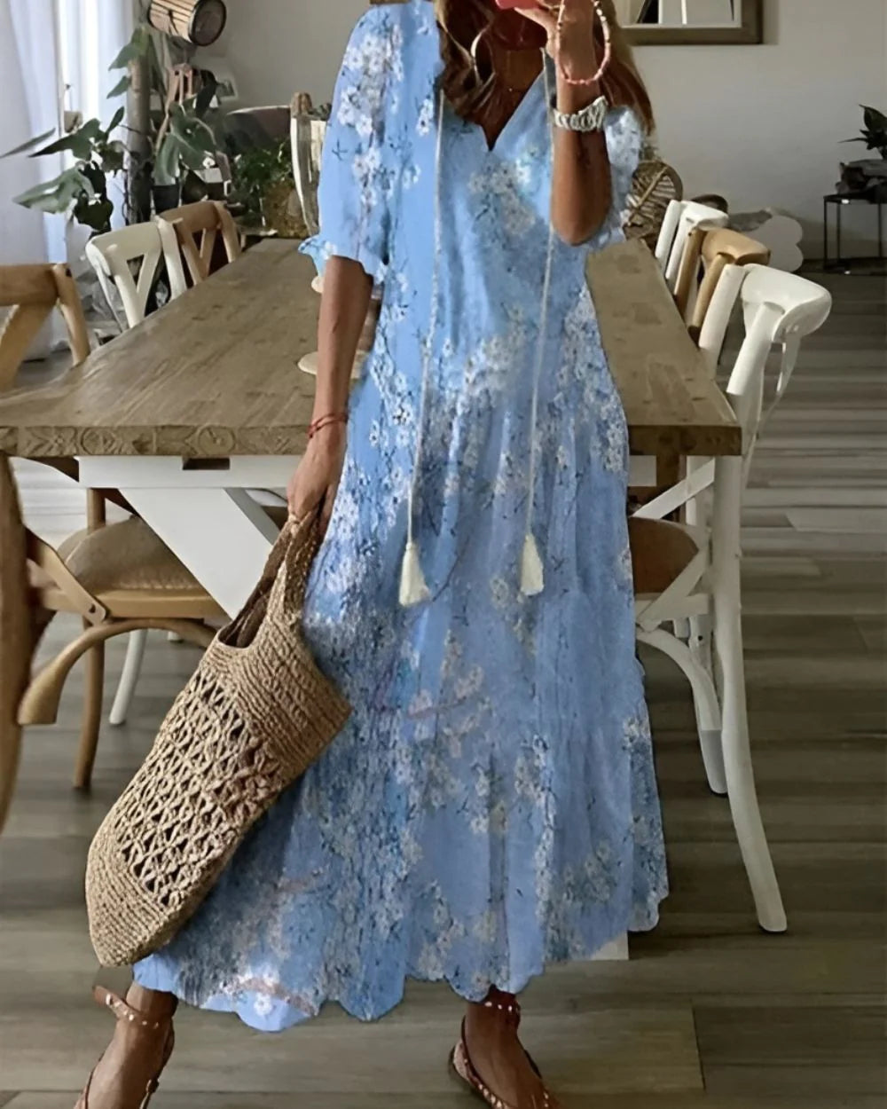 Detail of short sleeves and loose silhouette on tassel tie maxi dress