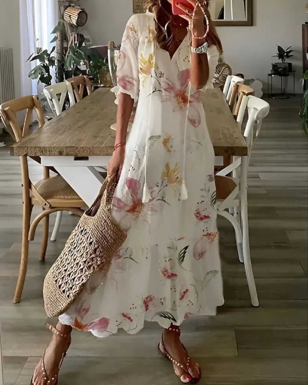 Woman styling tassel tie front maxi dress with flat sandals and woven bag