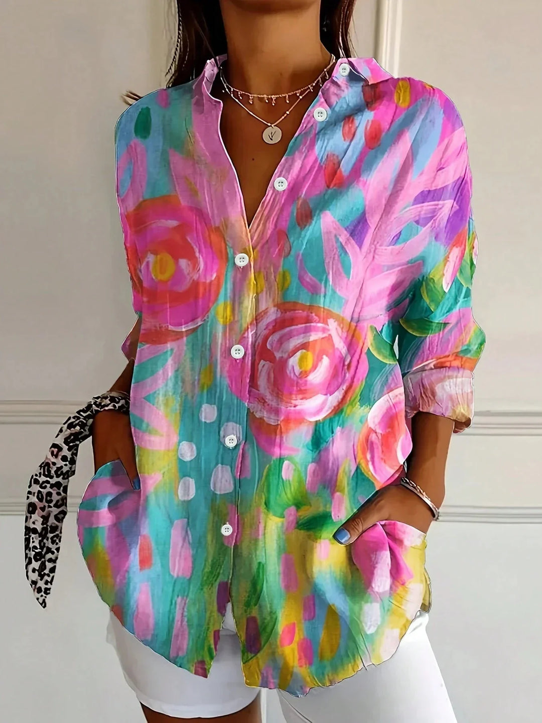 Women's abstract print button front blouse with vibrant floral design and collared neckline