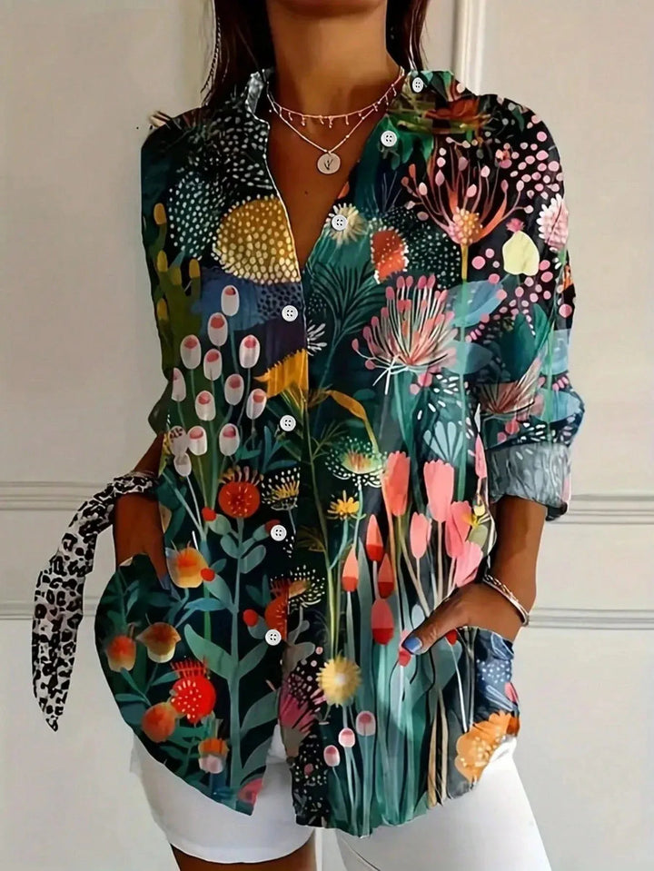 Side view of women's relaxed fit blouse with colorful abstract print and flowing silhouette