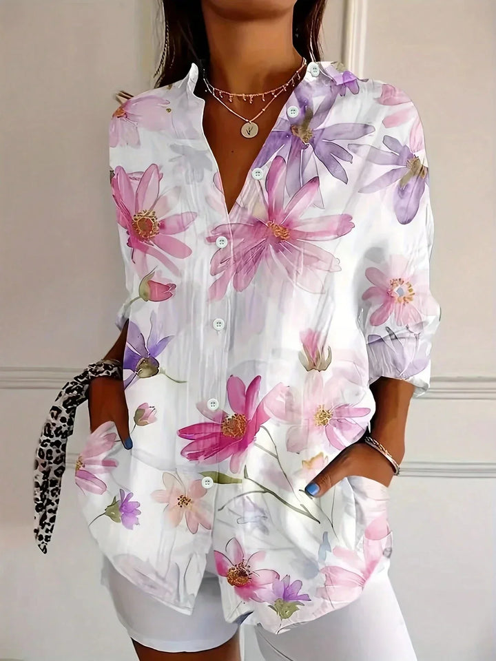Detail shot of button front blouse with pink turquoise and yellow abstract floral pattern