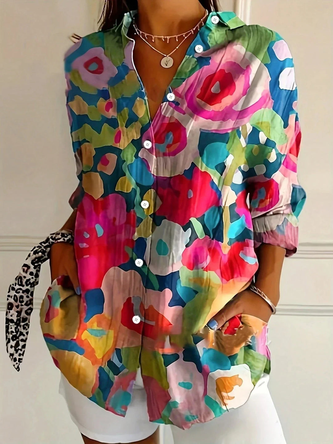 Women's long sleeve blouse with collared neckline and vibrant multicolor abstract print