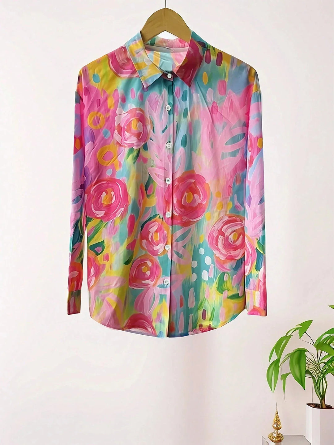 Full-length view of abstract print blouse paired with white pants for casual styling