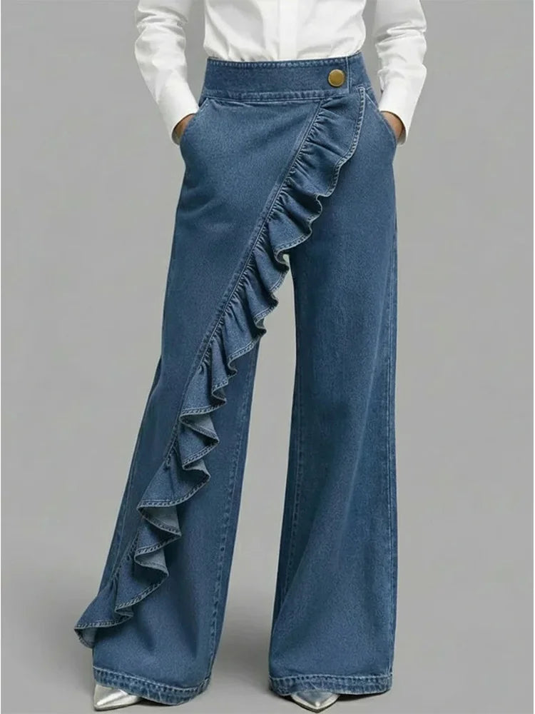 Women's high rise wide leg jeans in medium wash denim with asymmetrical ruffle detail down one leg