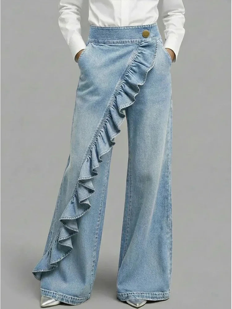 Close-up of asymmetrical ruffle detail on women's wide leg jeans with structured denim fabric
