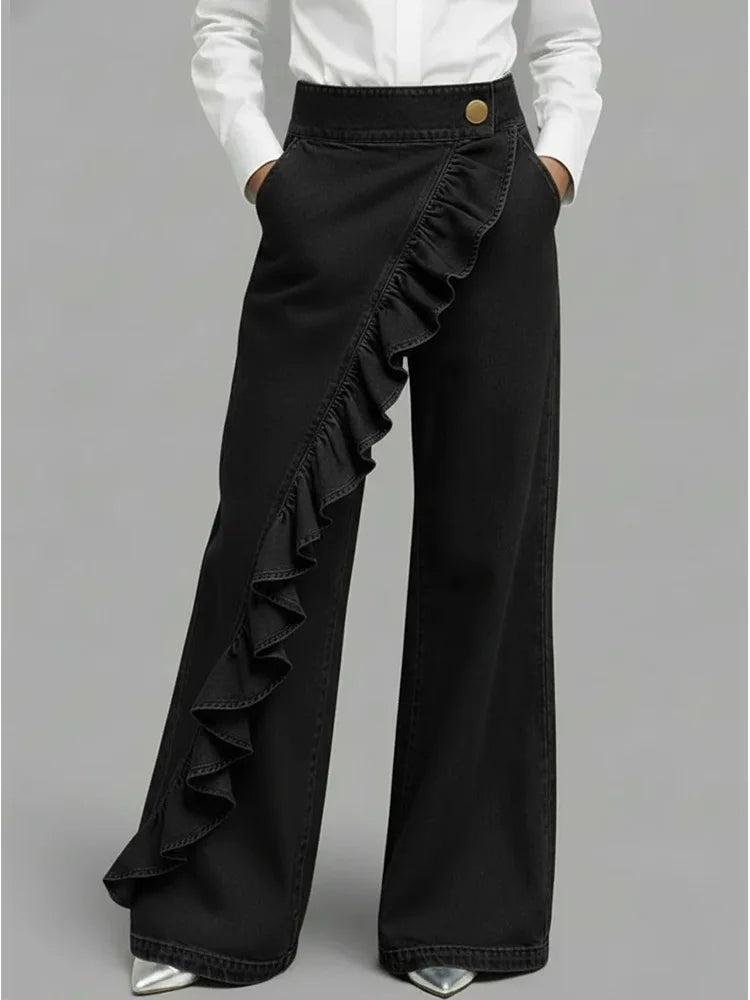 Full-length view of women's statement wide leg jeans paired with white shirt and silver heels