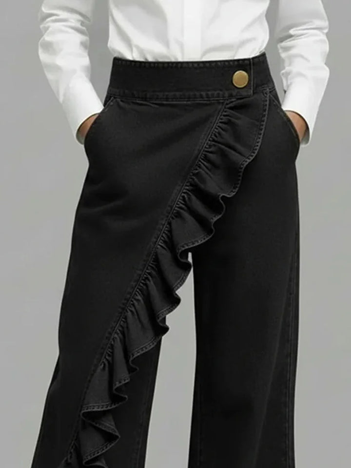 Detail shot of high-rise waistband with button closure on women's wide leg jeans