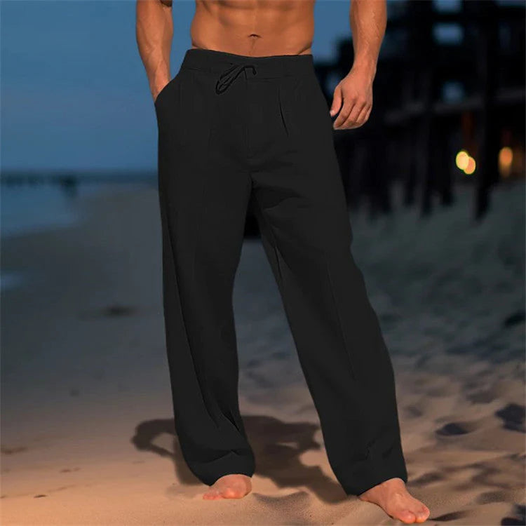Men's straight-leg drawstring pants in white worn with casual summer styling