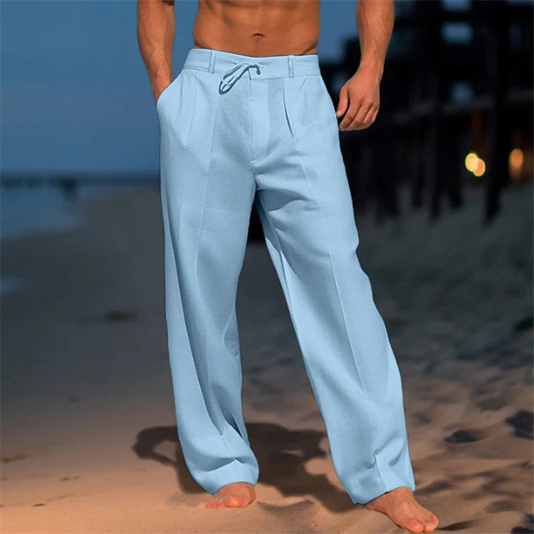 Full-length view of men's relaxed beach pants with pleated front and natural drape