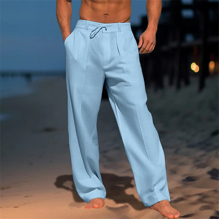 Full-length view of men's relaxed beach pants with pleated front and natural drape
