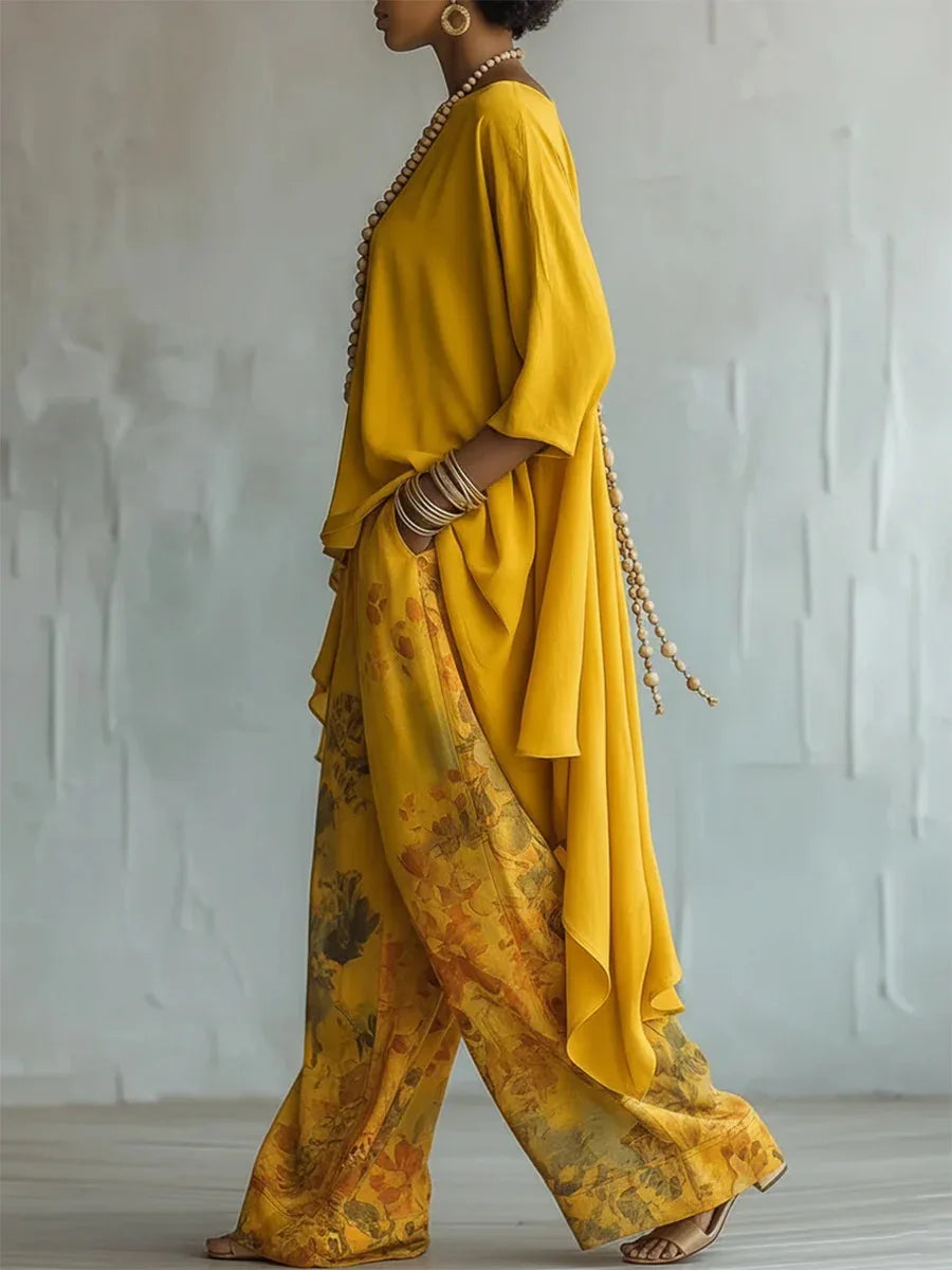Close-up view of the floral printed wide leg pants and layered hem detail on the two-piece set