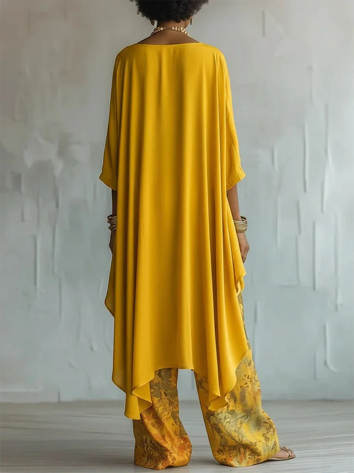 Side angle showing the flowing asymmetrical drape and relaxed silhouette of the printed two-piece set