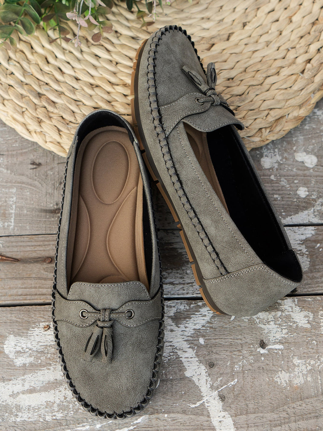 Women's vintage loafers worn casually with distressed jeans and ankle bracelets