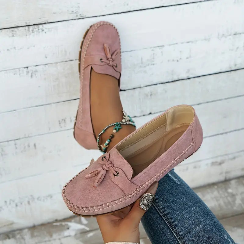 Close-up of slip-on loafer bow detail and hand-stitched trim on synthetic upper