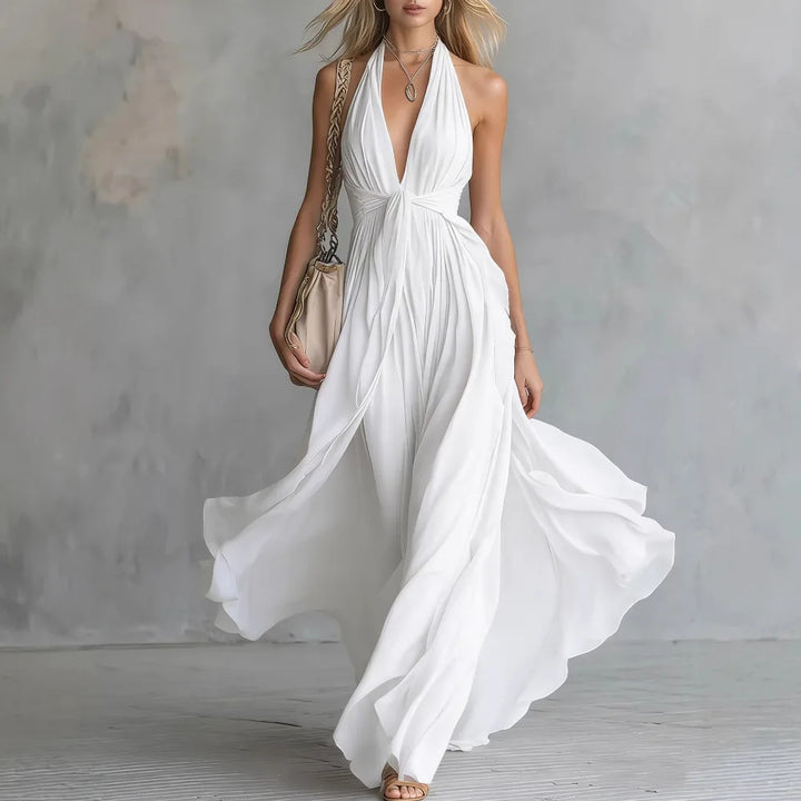 Side view of flowy evening dress showing open back design and draped maxi silhouette in motion