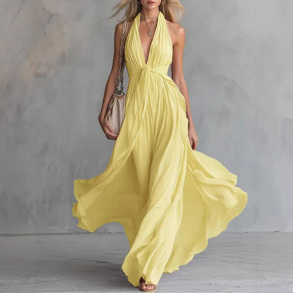 Full length flowy evening dress with soft pleated waist detail and halter neck tie closure